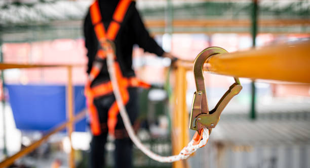 construction worker hooked up to safety rail